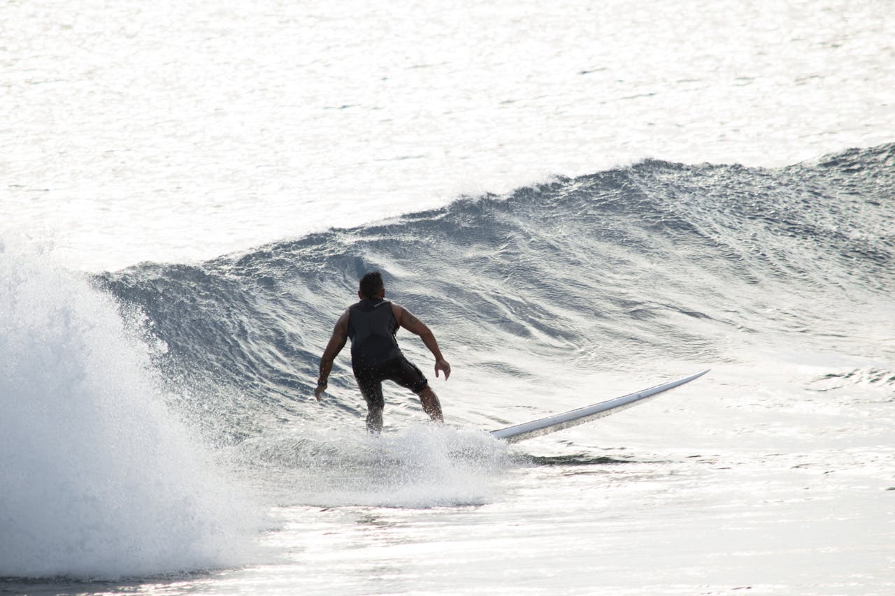 A surfer skillfully rides a wave in Honolulu, capturing the essence of Hawaiian water sports.
